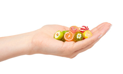 Hand with colored round candy, sugar lollipop