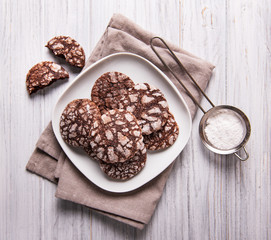 Crackled chocolate cookies on a old wooden table