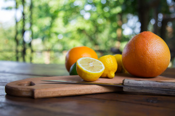 citrus fruits (grapefruit, orange, lemon, lime), on the wooden background.