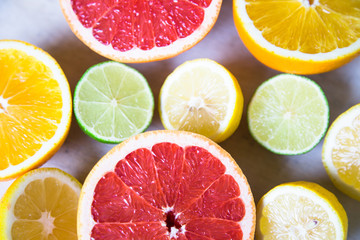 citrus fruits (grapefruit, orange, lemon, lime), on the wooden background.