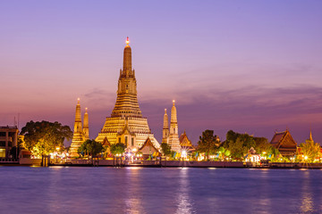 Fototapeta premium Wat Arun Ratchawararam Ratchawaramahawihan z odbiciami na rzece w czasie zachodu słońca