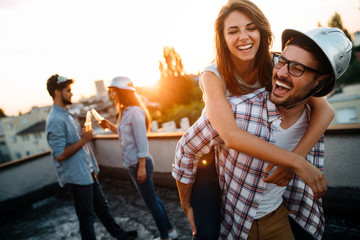 Fototapeta premium Group of happy friends having party on rooftop