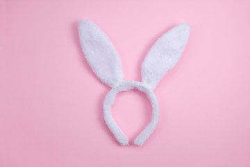 Easter bunny ears isolated on pink background. Happy Easter holiday background concept. Flat lay.