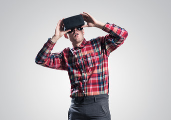 Guy in mask experiencing virtual reality as new entertainment device