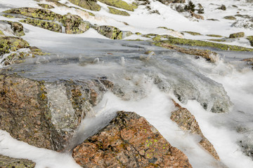 rocks covered with ice, water and snow in the mountains of Madrid