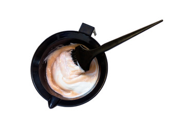 Mixing hair dye in a special plastic bowl. Concept is hair coloring. Isolated on white.