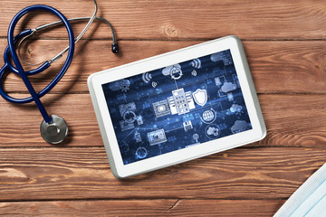 Concept of modern medicine with tablet on wooden table from top view