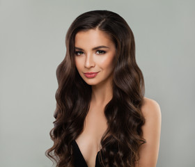Naklejka premium Pretty woman brunette fashion portrait. Cute girl with curly hairstyle