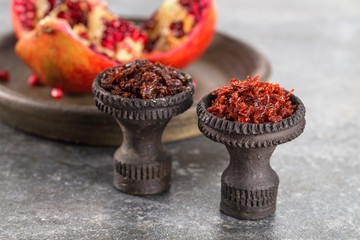 Different varieties of Shisha Smoking hookah. Black annealed ceramic bowl for hookah in the...