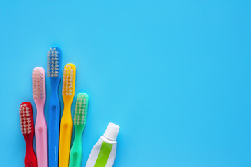 Toothbrush with toothpaste used for cleaning the teeth on blue background
