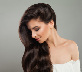 Pretty brunette woman with wavy hairstyle. Beautiful female profile. Hair care concept