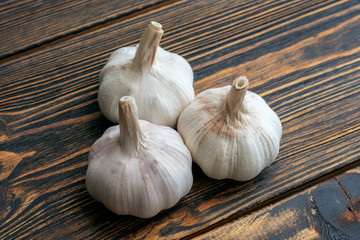 Garlic on wooden background.