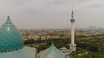 aerial view minaret mosque Al Akbar against city Surabaya highway, skyscrapers, buildings and houses. mosque in Indonesia Al Akbar in Surabaya, Indonesia. beautiful mosque with minarets on island Java
