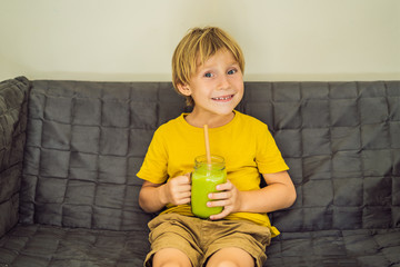 The boy is drinking Green tea latte with ice in mason jar. Homemade Iced Matcha Latte Tea with Milk...