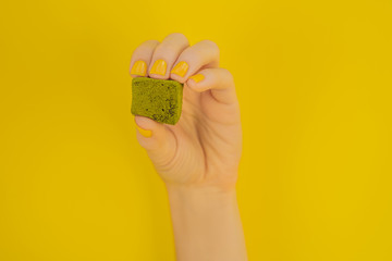 Matcha candy on yellow background. Homemade Matcha