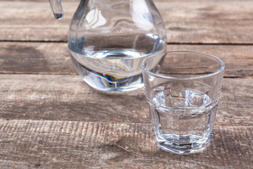 Glasses of water on a wooden table.