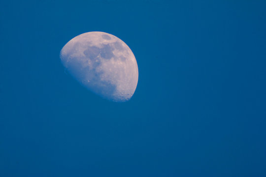 Half moon In the daytime with Sky Blue
