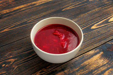 Borscht in a Cup on a wooden table. Traditional cuisine.