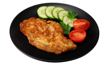 schnitzel with tomato and cucumber on black plate isolated on white background