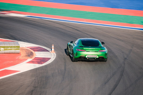 Beautiful Green Race Car Rides Along Race Track