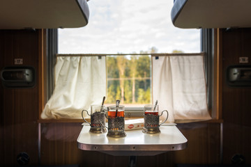 glasses, cups of tea on the table in the train