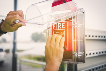 safety officer working on checking Fire extinguisher at outdoor plant