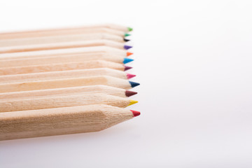 Colorful pencils in a row on white background - 246124078