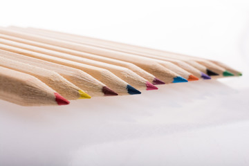 Colorful pencils in a row on white background - 246124277