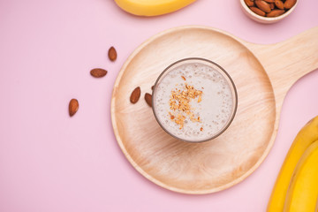 Fresh made Banana smoothie on pink background