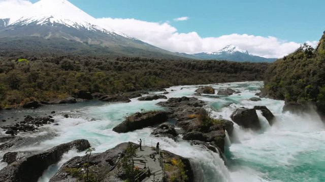 Aerial view of the tourists on the cascades in Petrohue at the slopes of the volcano Osorno, Chile. 4k