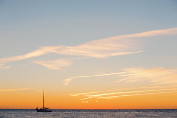 Lonely boat floats on a quiet warm calm sea
