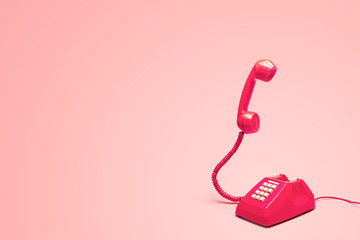 Retro pink telephone on retro pink background