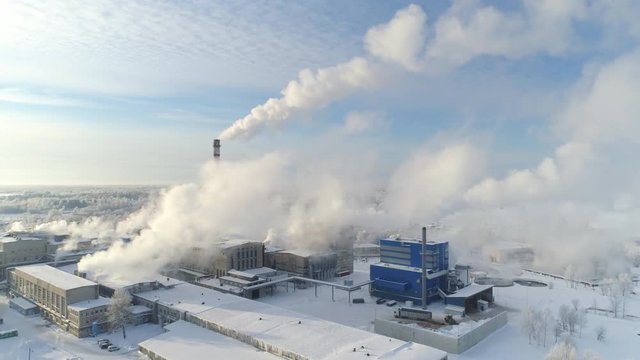 Smoke rising from cellulose factory on cold winter day aerial view