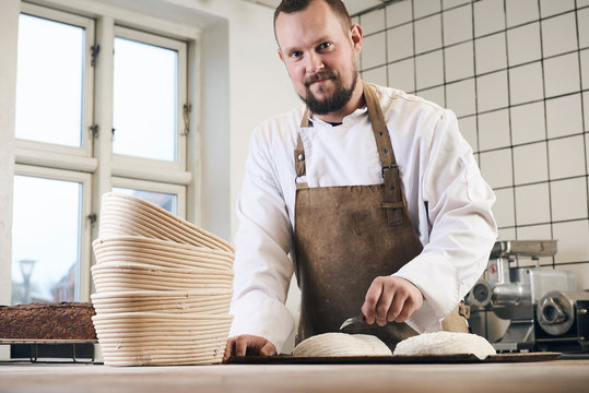 A smiling man with his delicacies and charcuterie