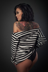 young woman in stripped vest on a dark  background studio shot