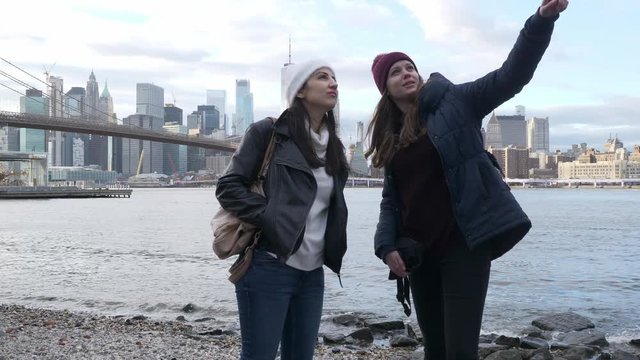 Two young women in New York enjoy the breathtaking Manhattan Skyline