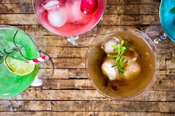 Colorful cocktails on wooden table top view
