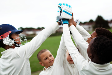 Group of young cricketers doing a high five