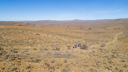 Fototapeta na wymiar Aerial image of a group of hikers doing a hiking train in the karoo region of south africa