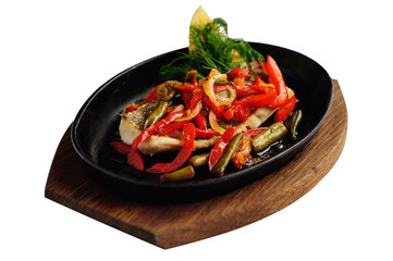 Grilled fish and vegetable in cast iron pan