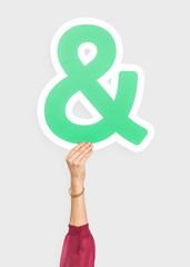 Hand holding an ampersand sign