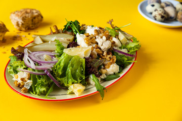 Lettuce salad with pear,walnut, cheese and onion.