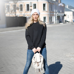 Street fashion look. Beautiful girl in black hoody