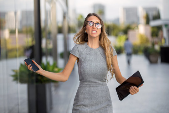 Business Person Overwhelmed With Anxiety, Overworked, Hands Full With Technology Devices