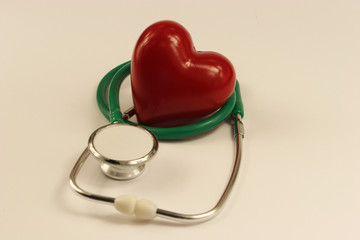 Stethoscope and heart on white background.