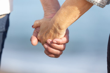man and woman hands joined together