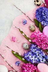 Beautiful hyacinths, willow and  Easter eggs on light background, top view, spring holiday concept