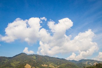 Fototapeta premium Sky with white clouds floating over mountains