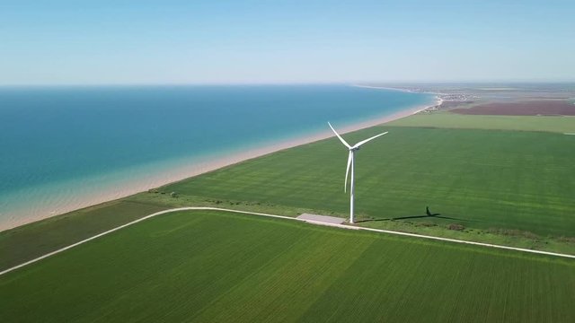 Aerial view at wind power station on field. Technology and inovation. Green energy composition. Wind turbines. Industrial landscape