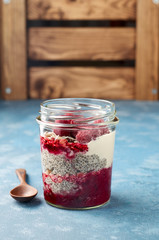 Raspberry chia seed yogurt pudding with muesli and fresh berries
